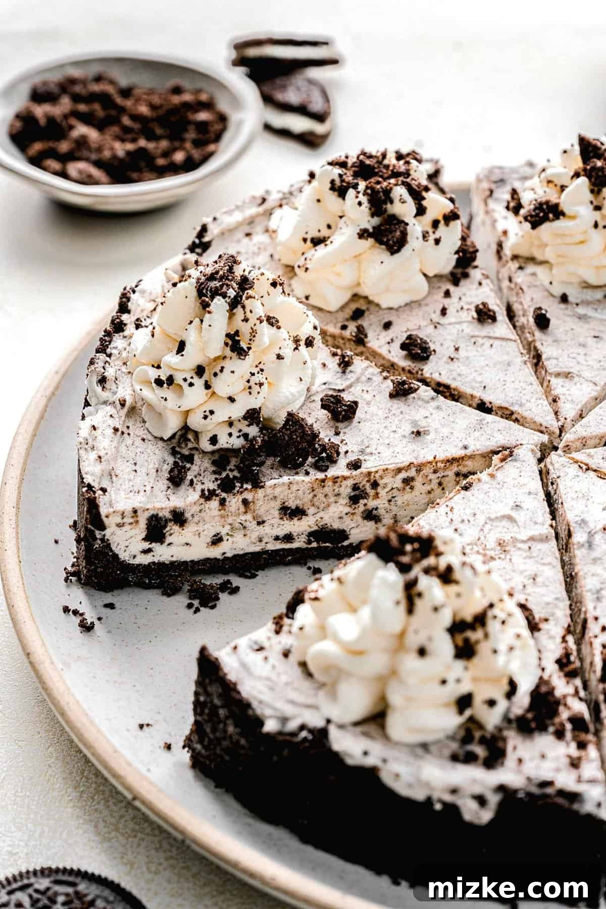 A slice of Oreo pie on a serving plate, showing its layers and ready to be enjoyed.