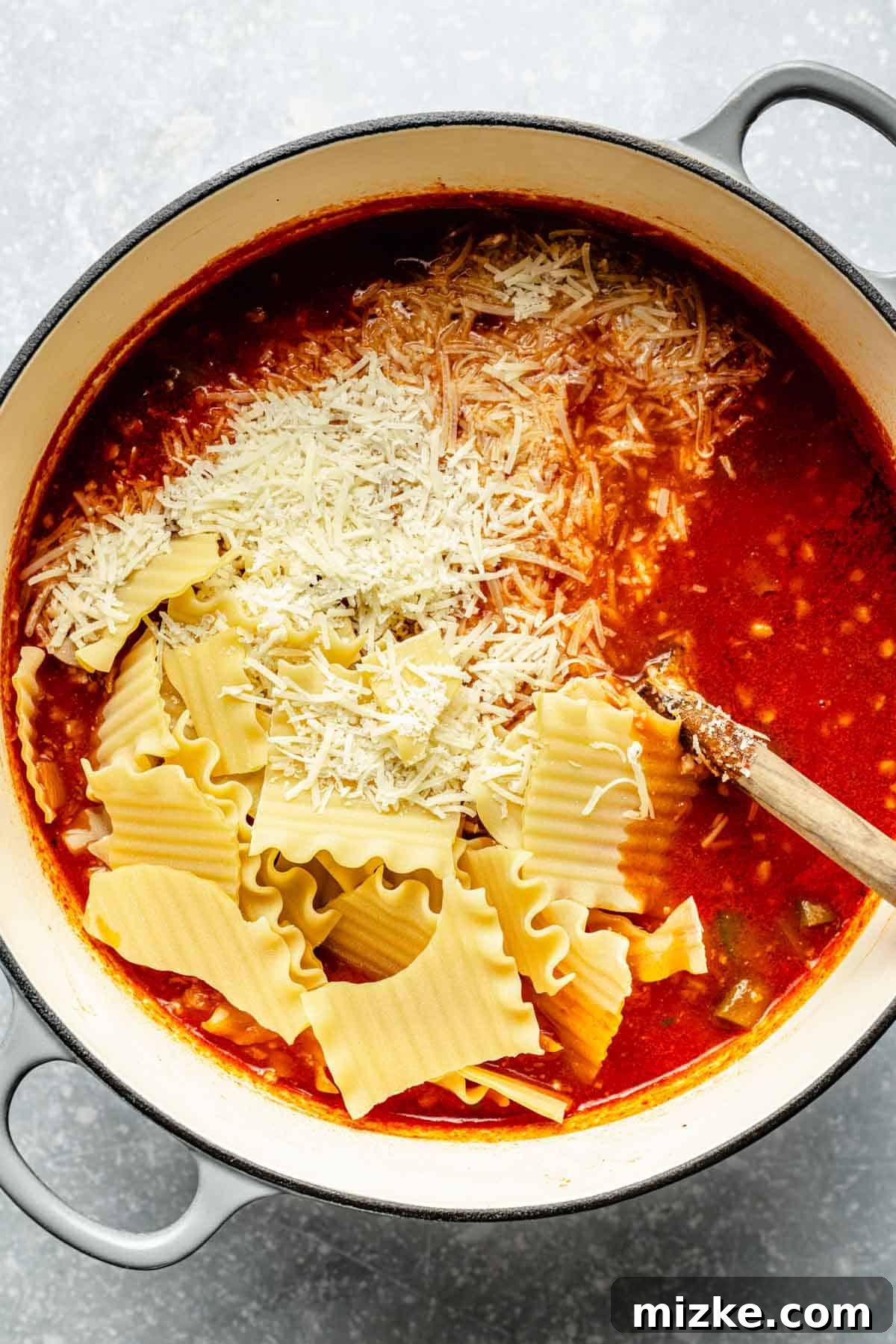 One-Pot Lasagna Soup 8 broken lasagna noodles and parmesan cheese added to the pot of soup
