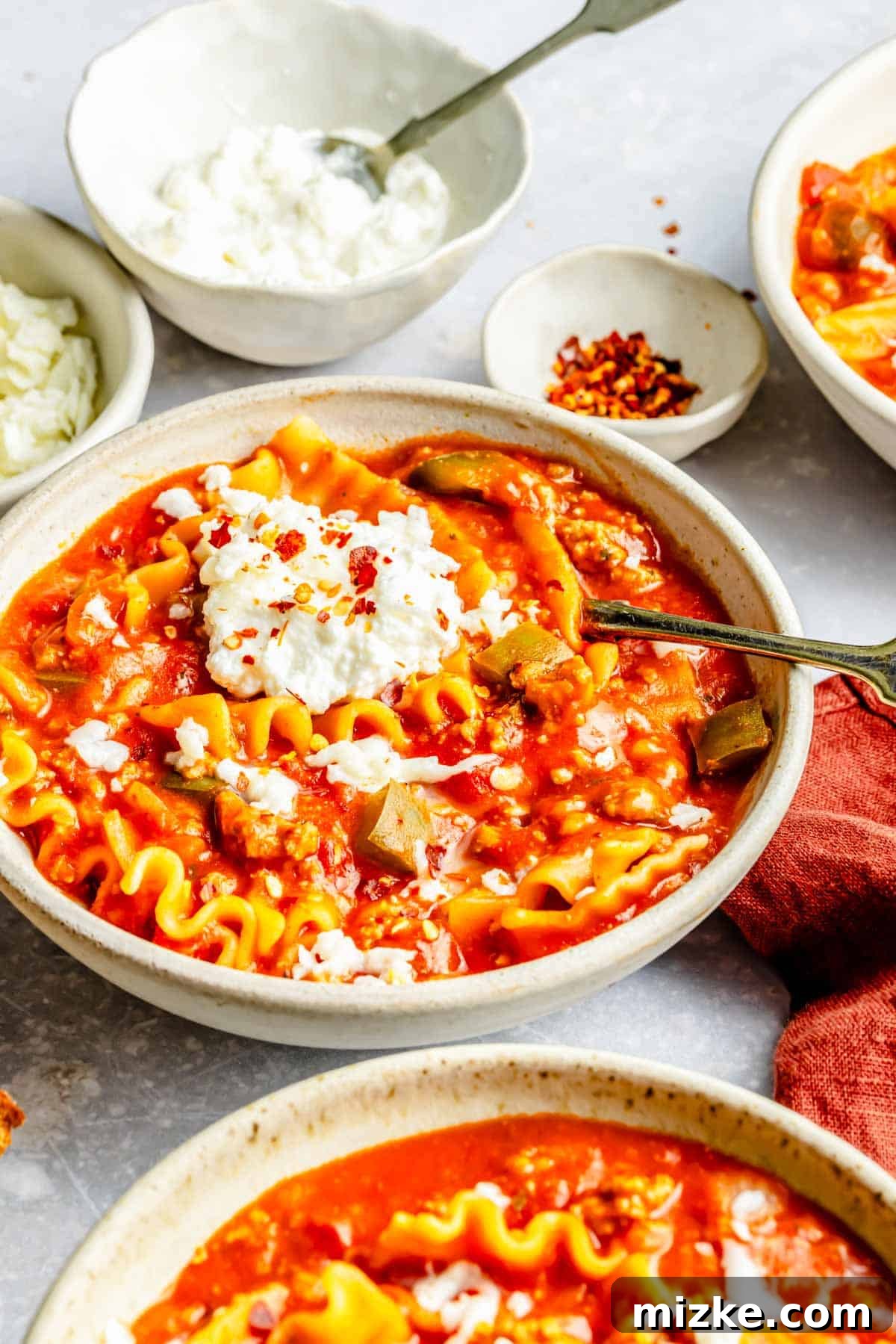 One-Pot Lasagna Soup 9 several bowls of lasagna soup next to each other