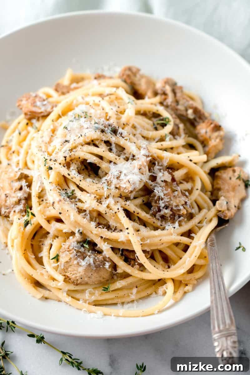 Velvety Lion's Mane Mushroom Pasta 2 creamy lions mane pasta in a white bowl with a metal fork