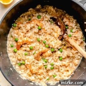 Creamy Shrimp Risotto 6 Shrimp risotto in a pot with a wooden spoon.