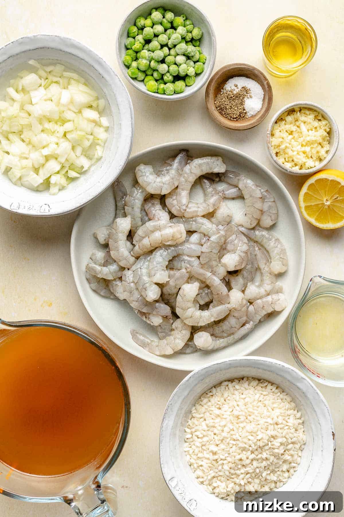 Key ingredients for a delicious and easy shrimp risotto recipe. Fresh ingredients for making shrimp risotto laid out on a wooden surface.