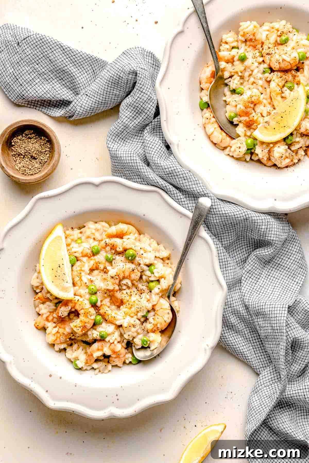 Delicious homemade shrimp risotto served in bowls. Overhead shot of two bowls filled with creamy shrimp risotto, garnished and ready to eat.