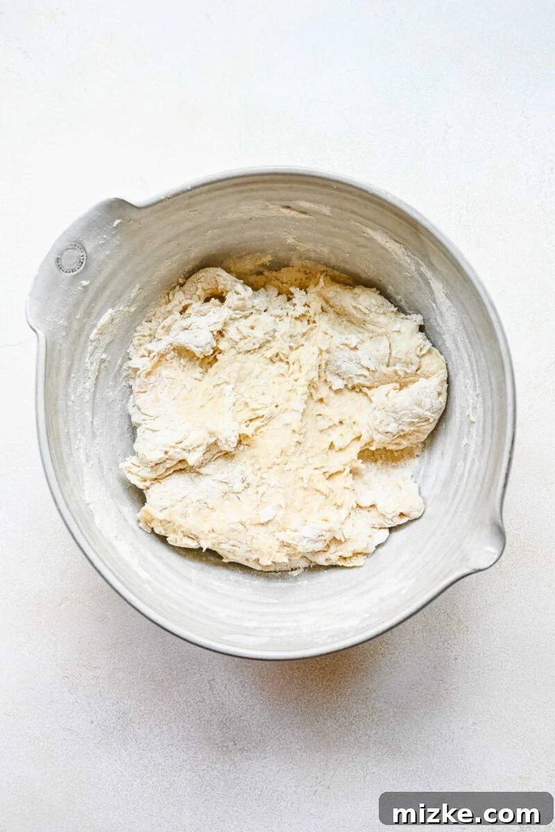 Kneading bao bun dough on a floured surface