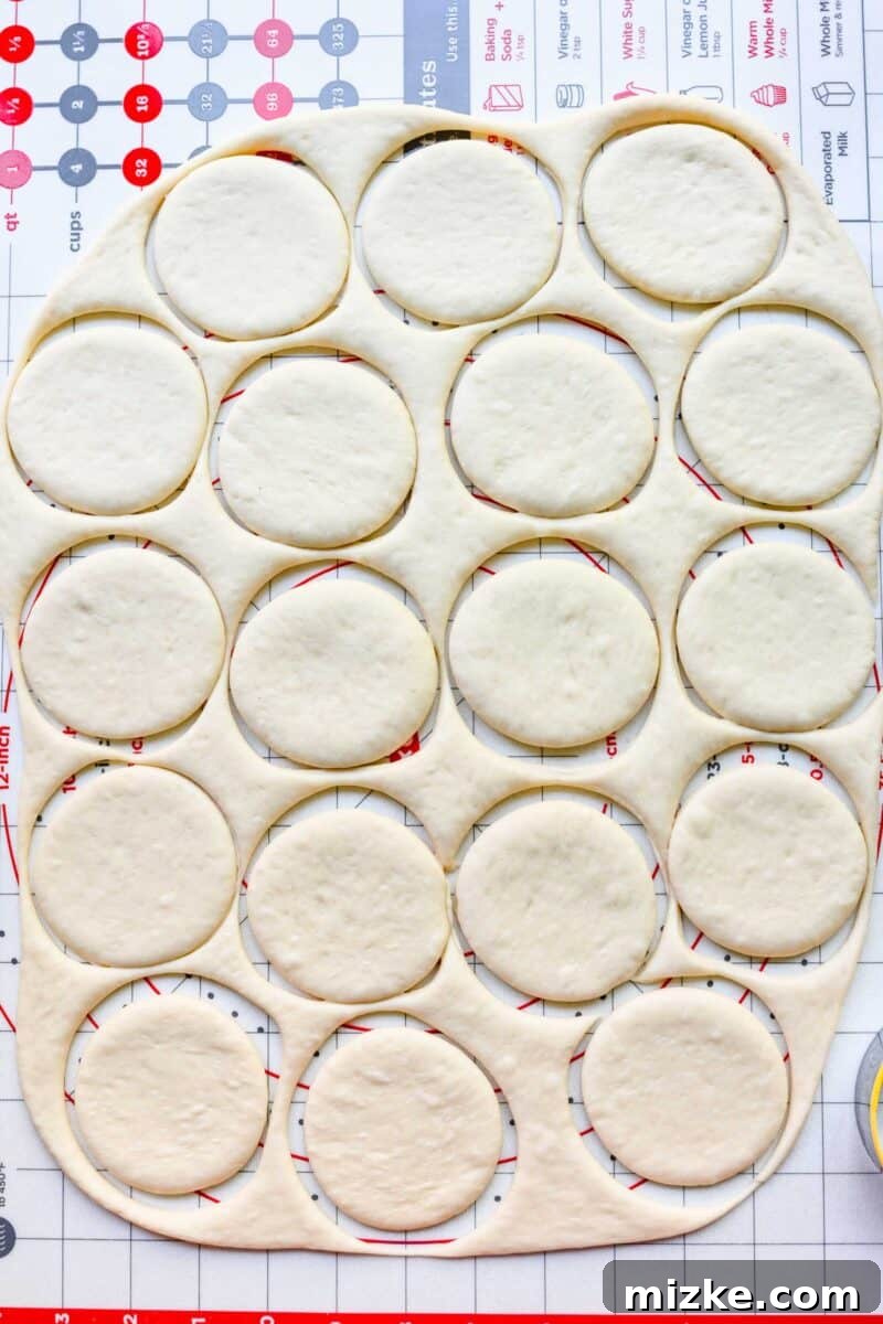 Cutting bao bun dough into circles with a cookie cutter