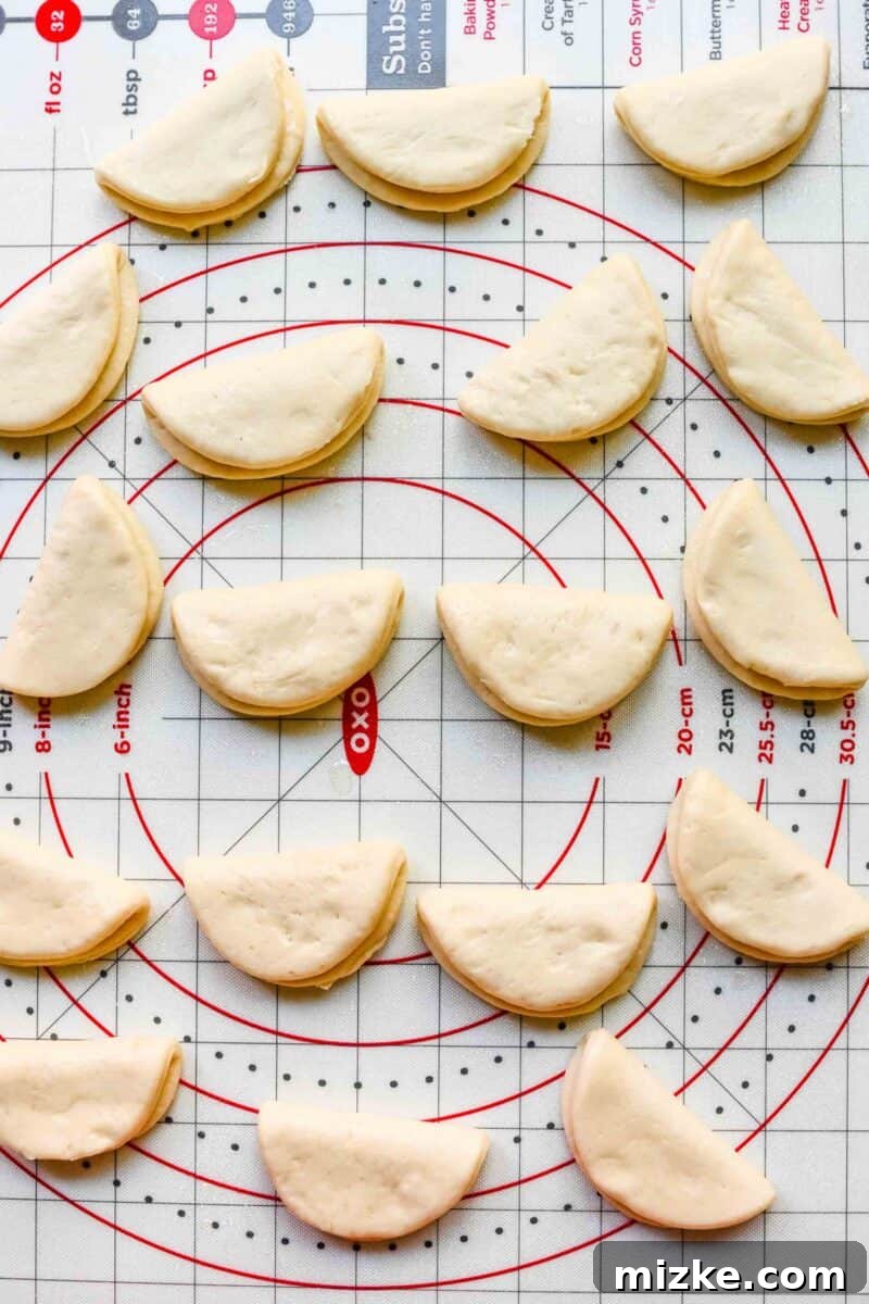 Folding circular bao dough into half-moon shapes