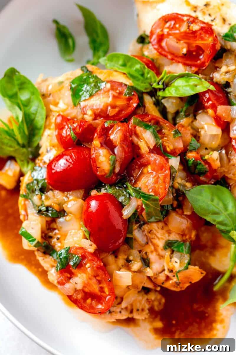 Skillet Roasted Garlic Tomato Basil Chicken 5 fresh grape tomatoes and basil and onions on top of chicken breasts