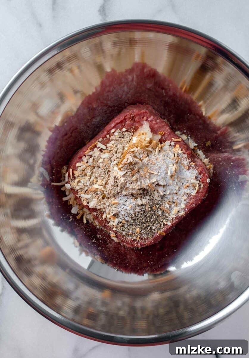 Golden State Delight 5 ground beef, onion mix, white onion, salt, and pepper in a metal bowl