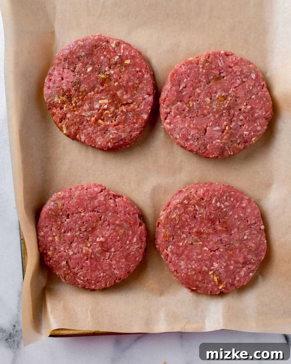 Golden State Delight 7 four beef patties formed and placed on a brown piece of parchment paper
