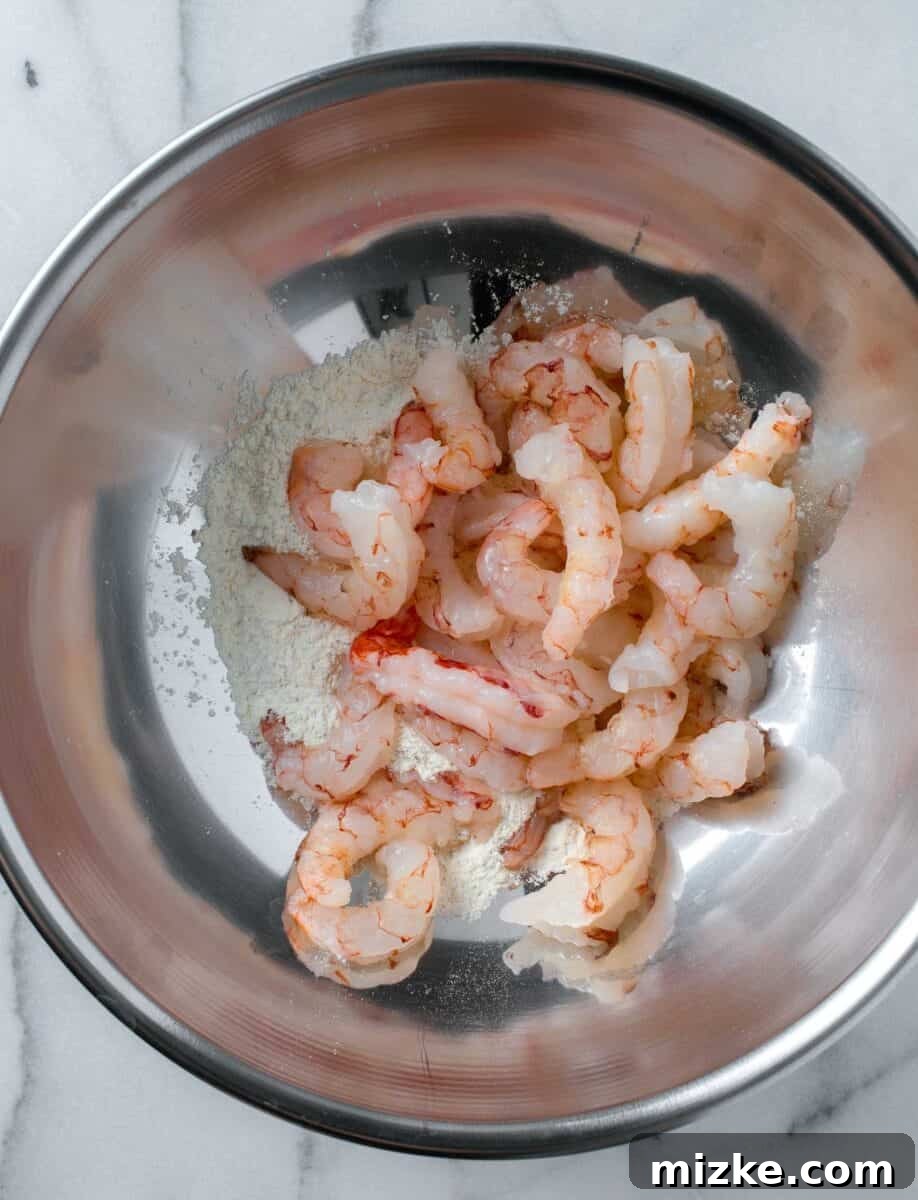 Zesty Lemon Pepper Shrimp 5 raw shrimp added to the metal bowl with the lemon pepper shrimp seasoning