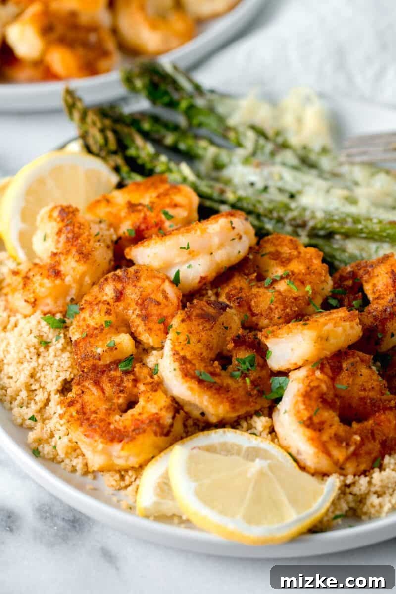 Zesty Lemon Pepper Shrimp 6 lemon pepper shrimp on a bed of couscous with fresh lemon slices and sprinkled fresh parsley on top