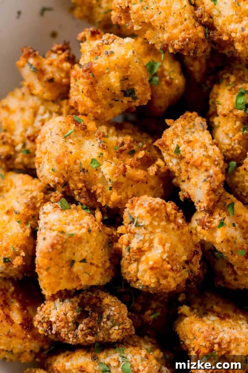 Close-up image showcasing the perfectly crispy coating on an air fryer chicken nugget, highlighting its golden texture