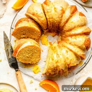 An inviting overhead image of the Glazed Orange Pound Cake with several slices cut and ready to serve, highlighting its moist interior and generous glaze.