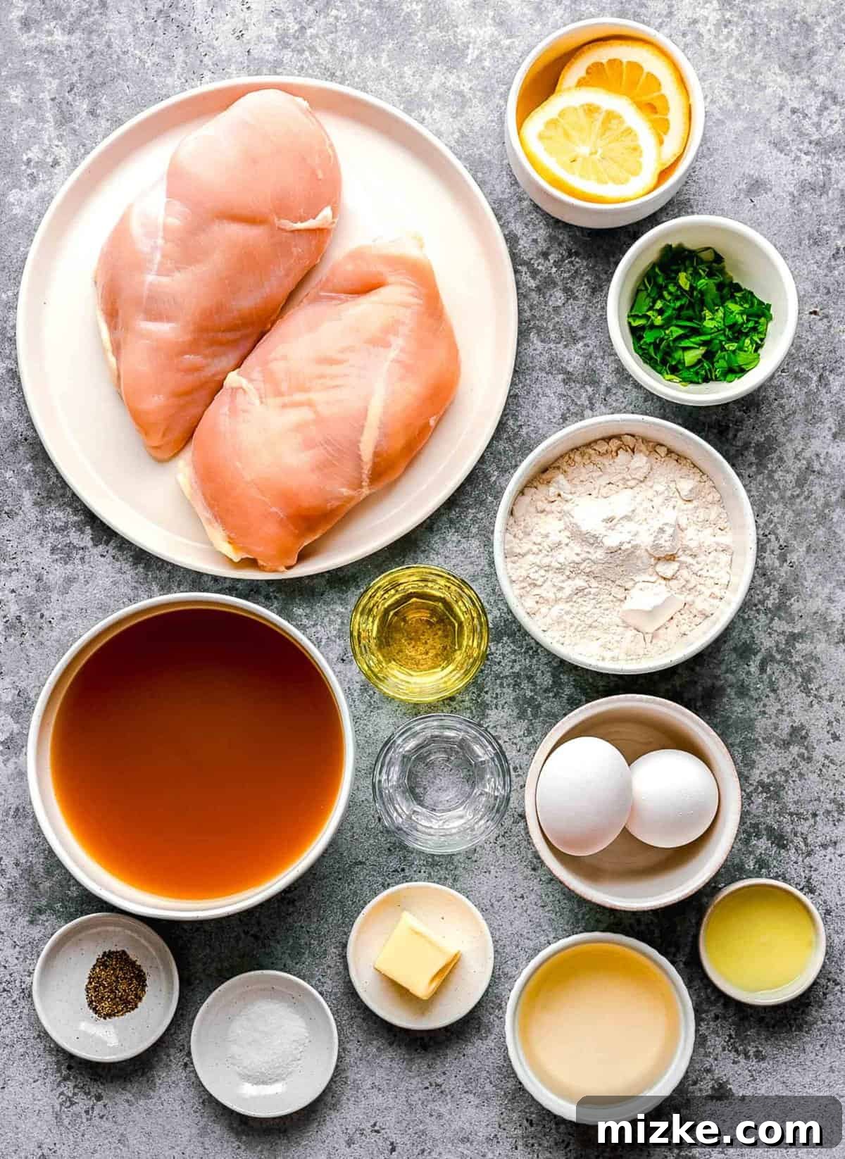 This easy chicken francese is made of tender chicken breast halves lightly breaded, pan-fried, and finished in a bright lemon-butter sauce. Ingredients for chicken francese arranged on a work surface.