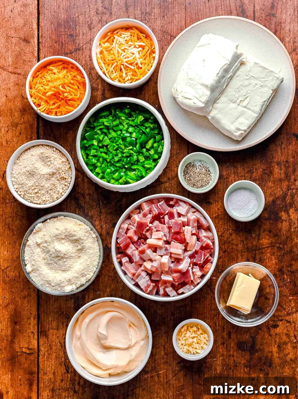 Individual ingredients for Jalapeño Popper Dip, neatly arranged in separate bowls, ready for preparation.
