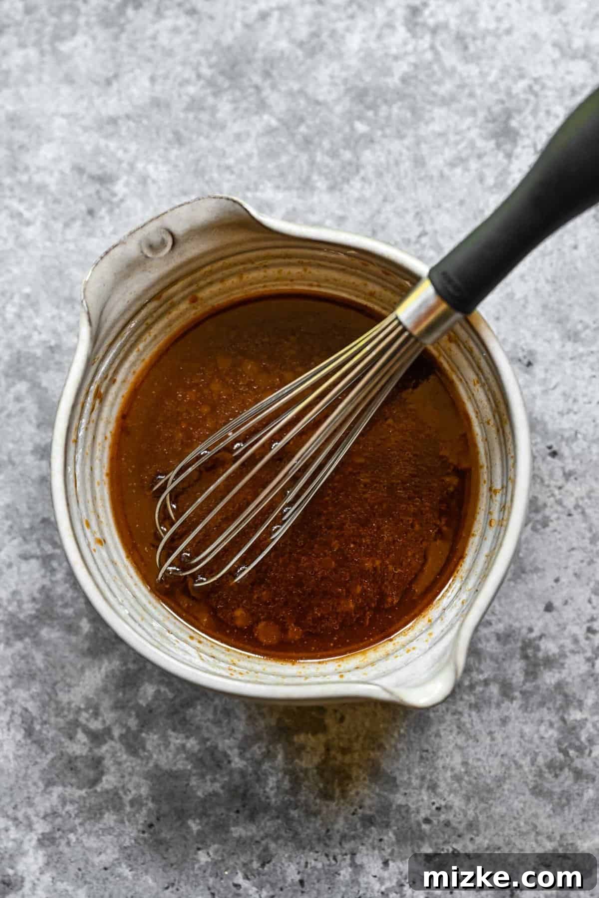 Preparing the delicious sauce for shrimp chow mein. Whisking together the savory-sweet chow mein sauce ingredients in a bowl.
