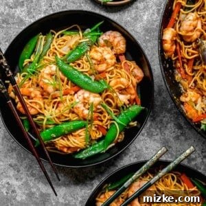 Ultimate Shrimp Chow Mein 2 Overhead shot of shrimp chow mein served in bowls with chopsticks, showcasing crisp noodles and fresh ingredients.