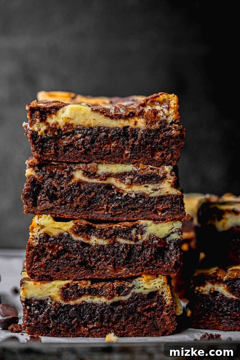 A stack of cream cheese swirl brownies.