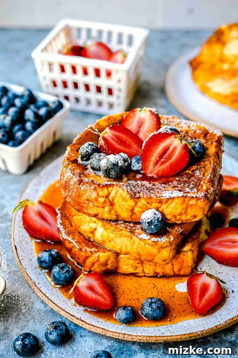 Decadent Pumpkin French Toast 3 pumpkin french toast drizzled with syrup with fresh strawberries and blueberries on top