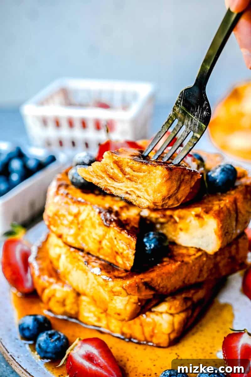 Decadent Pumpkin French Toast 4 a fork holds a piece of pumpkin french toast