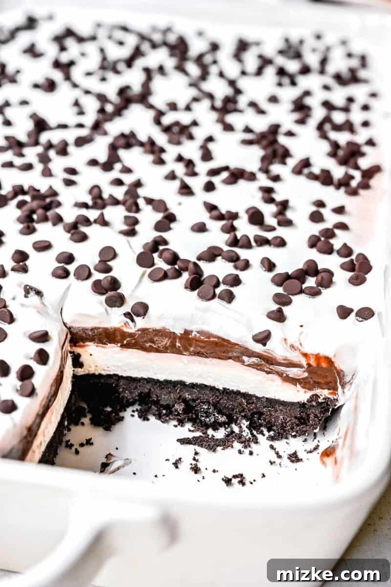 No-Bake Chocolate Dream 2 Layers inside a slice of chocolate lasagna showing the Oreo crust, cream cheese, chocolate pudding, and whipped cream