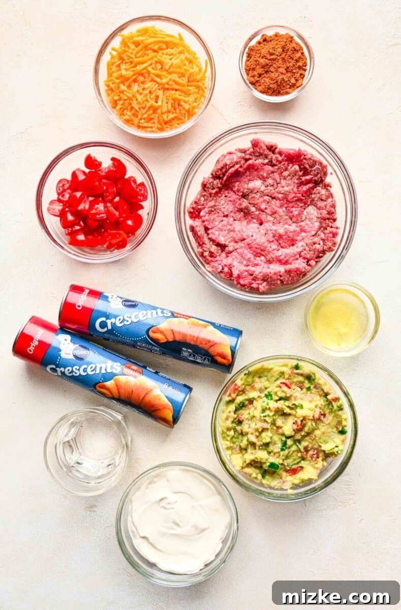 Essential ingredients for a taco ring: ground beef, taco seasoning, water, shredded cheddar cheese, crescent dinner rolls, and an egg white.