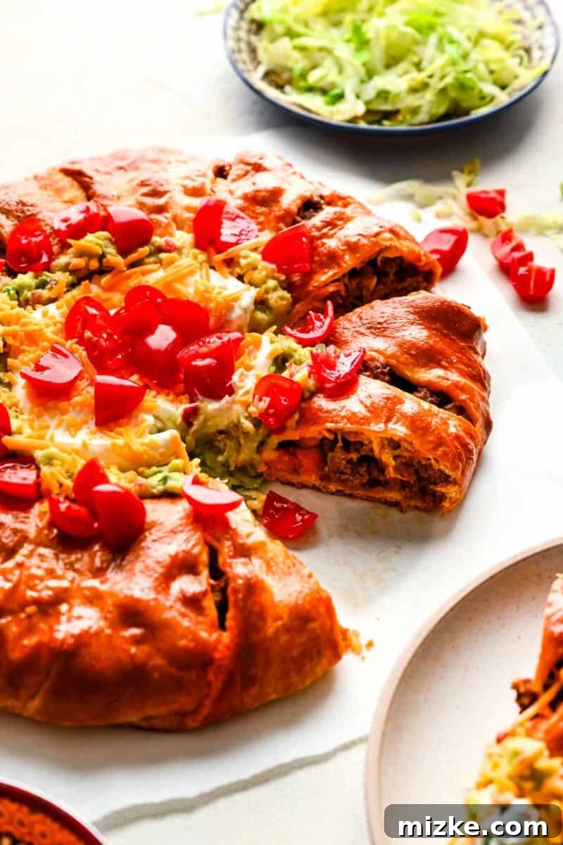 A beautifully baked taco ring, centrally topped with a vibrant array of fresh garnishes and dips, perfect for a party spread.