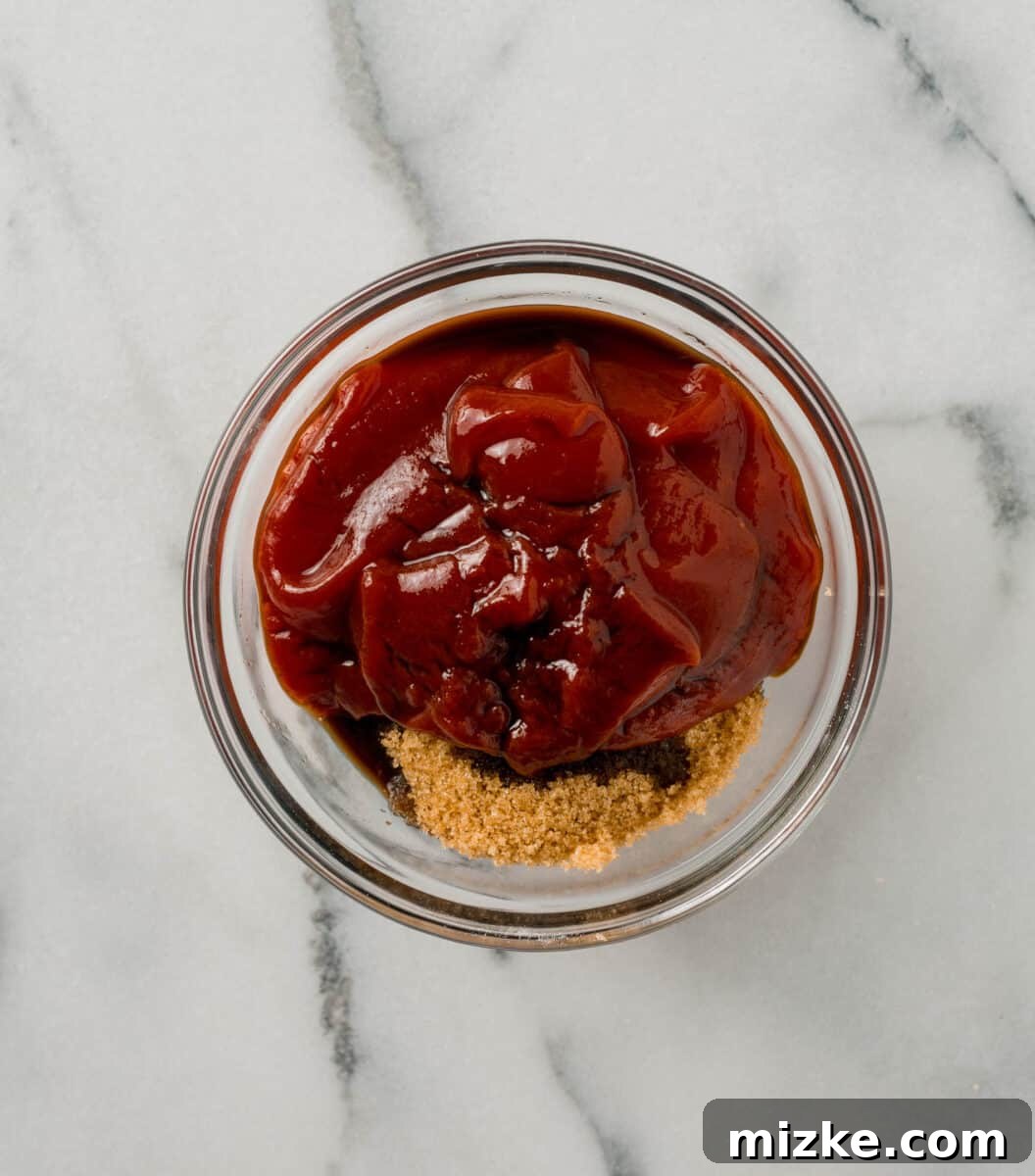 Ingredients for the sweet and tangy meatloaf glaze, including ketchup, brown sugar, and Worcestershire sauce, neatly laid out.