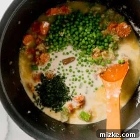 Hearty Stovetop Chicken and Dumplings with Biscuits 11 Peas, fresh parsley, and a chicken bouillon cube added to the liquid soup mixture.
