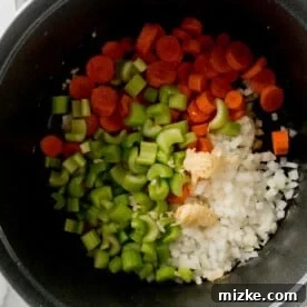 Hearty Stovetop Chicken and Dumplings with Biscuits 9 Carrots, celery, onion, and garlic added to a large Dutch oven for sautéing.