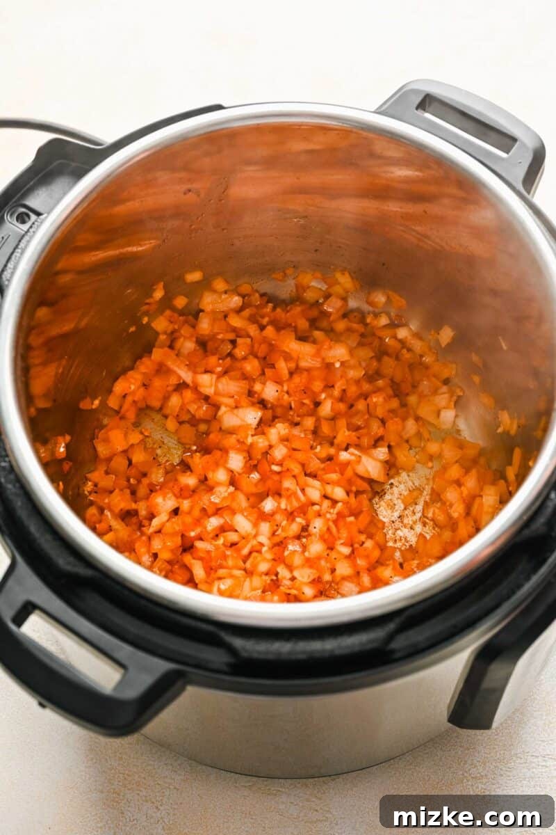 Perfectly Tender Instant Pot Pork Chops 6 Diced onions sautéing to translucent perfection in the Instant Pot insert