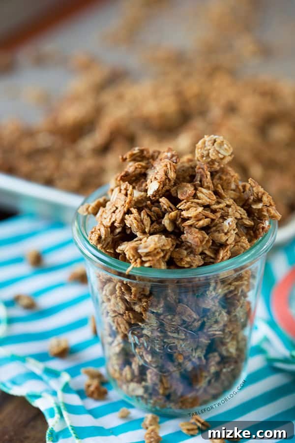 Peanut Butter Granola with Yogurt and Berries Peanut butter granola mixed with fresh berries and yogurt in a clear glass