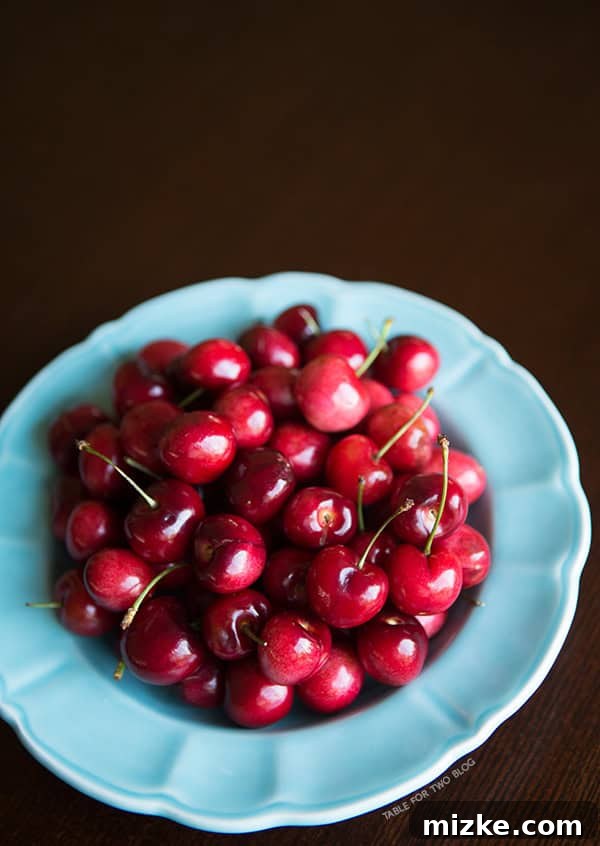 Cherry Almond Scones | tablefortwoblog.com A plate of several cherry almond scones, ready to be served.