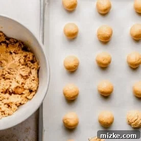 Forming peanut butter dough into balls.