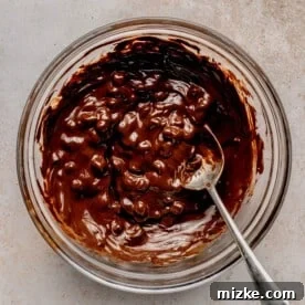 Melting chocolate chips and coconut oil together.