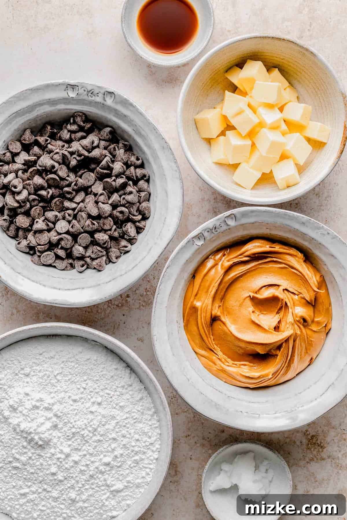 Creamy peanut butter sweetened with powdered sugar is rolled into balls and coated in chocolate to make these decadent peanut butter balls. All the essential ingredients for making homemade peanut butter balls, neatly arranged on a counter.