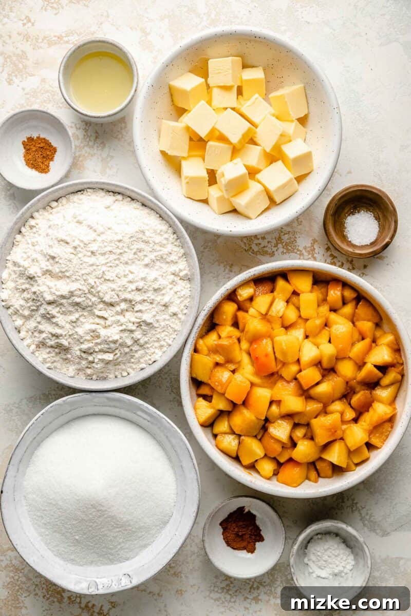 Golden Peach Crumble Squares 4 A collection of fresh ingredients for peach crumble bars, including whole peaches, flour, sugar, and butter, neatly arranged on a pristine white surface.