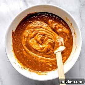 Combining wet and dry ingredients for sweet potato bread.