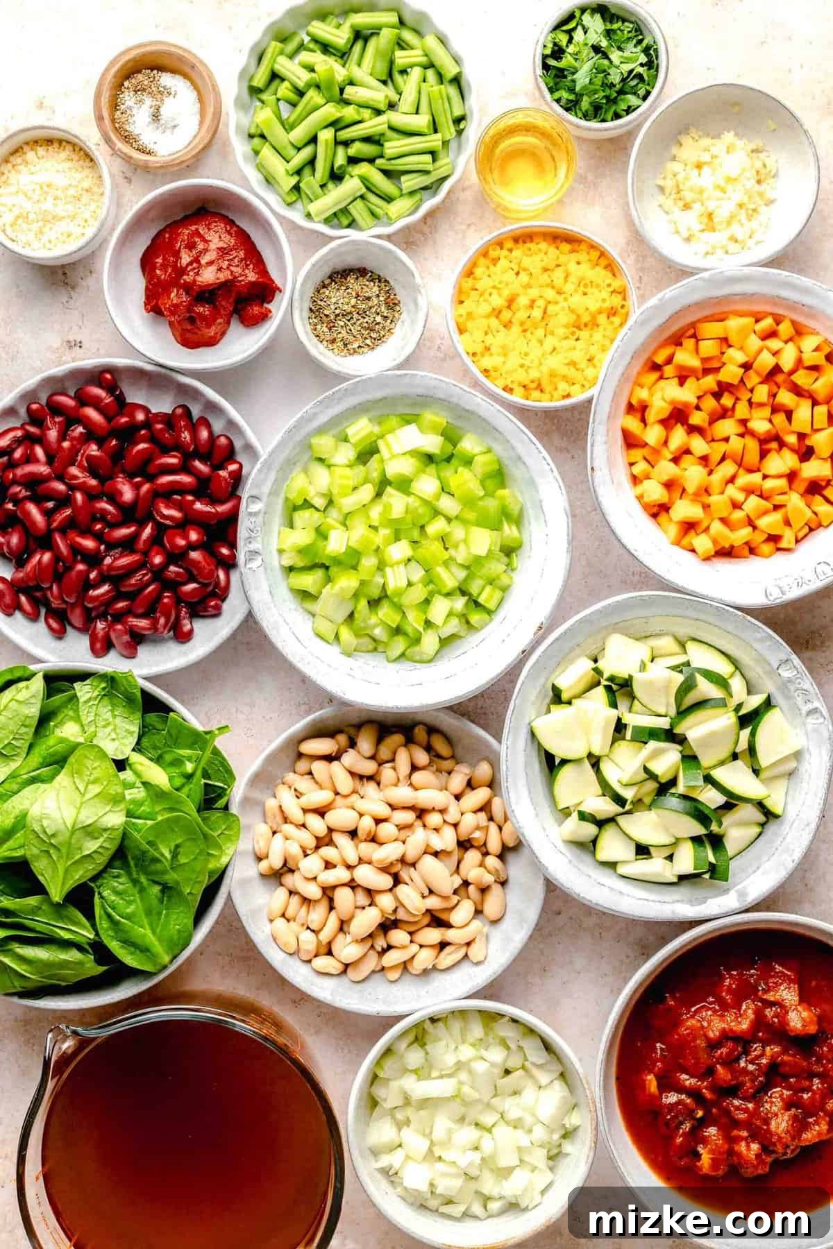 Loaded with tender veggies, beans, and pasta in a flavorful, tomato-y broth, minestrone soup is the perfect vegetarian main. Assortment of fresh ingredients laid out for making minestrone soup: fresh vegetables, beans, pasta, and spices.