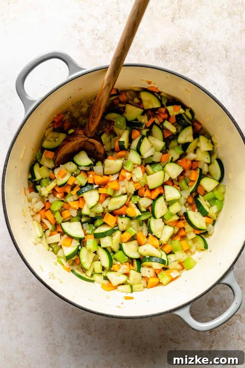 Loaded with tender veggies, beans, and pasta in a flavorful, tomato-y broth, minestrone soup is the perfect vegetarian main. Sauteing diced onions, carrots, celery, garlic, and zucchini in a large Dutch oven until tender.