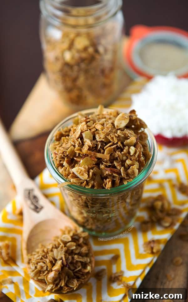 Freshly Baked Coconut Vanilla Granola - Table for Two Blog Golden Coconut Vanilla Granola cooling on a baking sheet