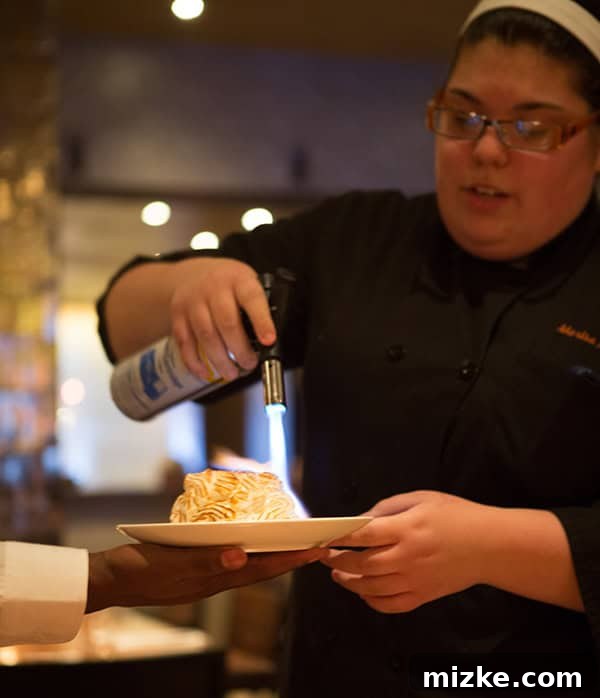 Feasting Through Music City 38 Innovative 'Pop of Summer' dessert featuring a lemon curd lollipop with Pop Rocks, lemon poppyseed cake, and blackberry rosemary foam