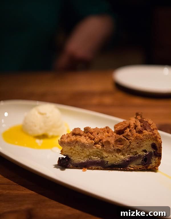 Feasting Through Music City 39 Pastry chef expertly torching the T.N. Bombe dessert, featuring peach ice cream, buttermilk cake, and Italian meringue