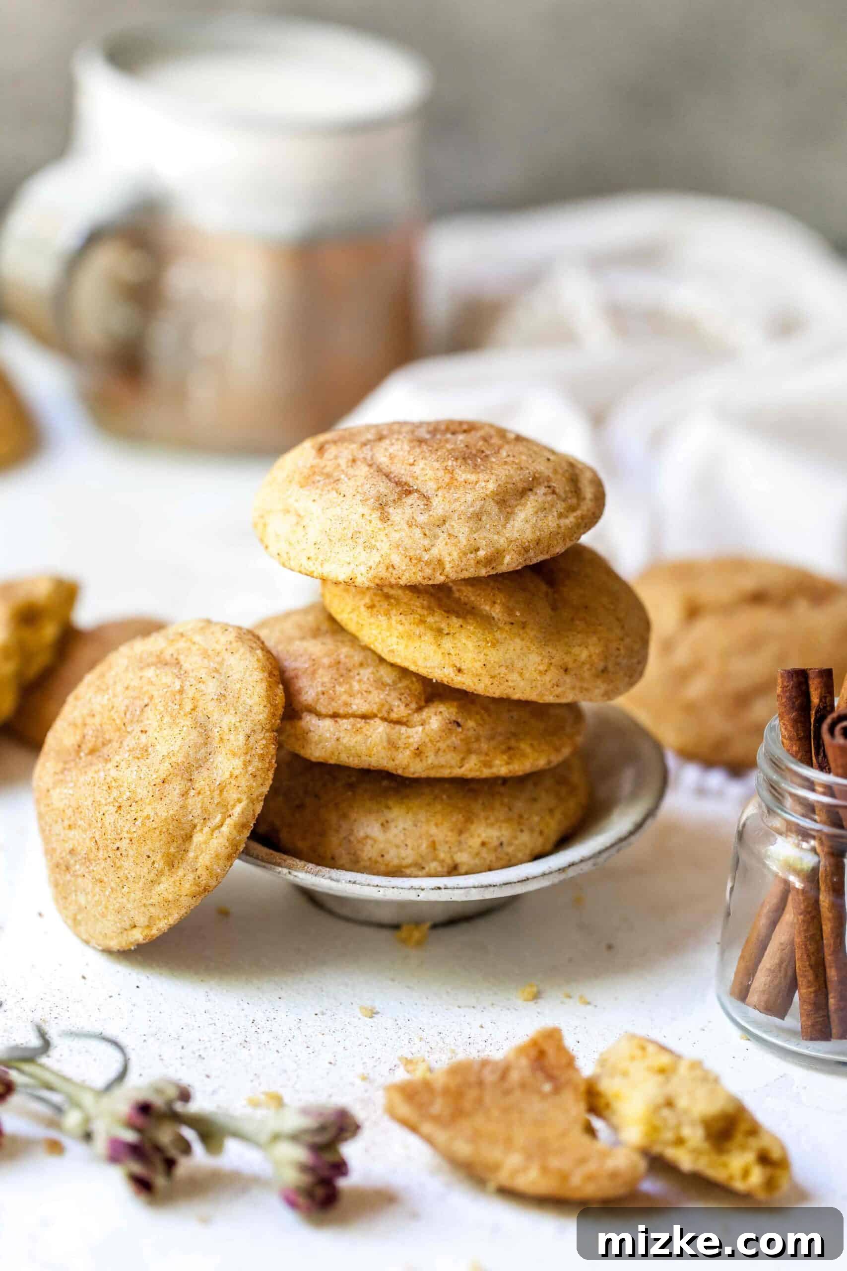 Harvest Pumpkin Spice Snickerdoodles 3 Close-up of freshly baked pumpkin spice snickerdoodles, showing their characteristic crinkled tops and cinnamon sugar coating.