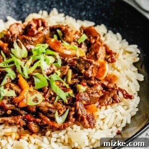 Korean beef bulgogi served over rice in a bowl.