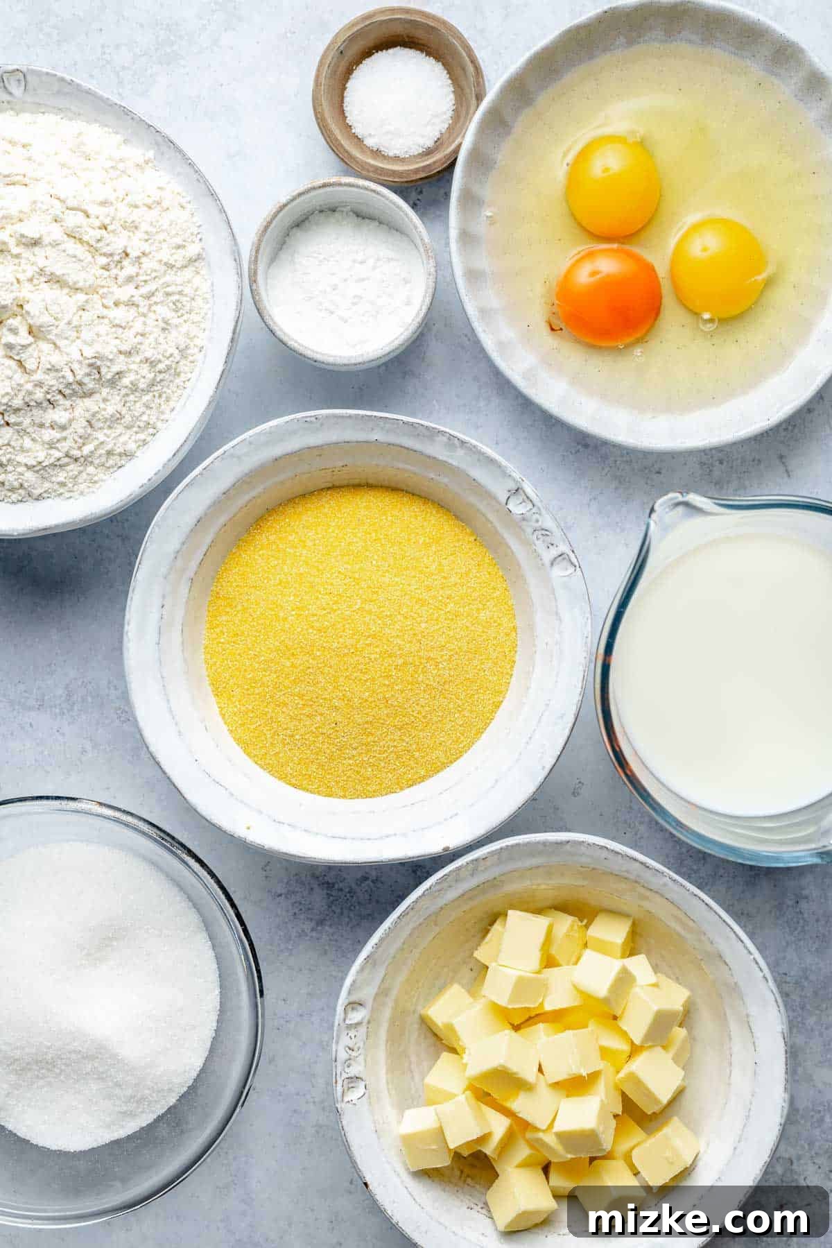 A collection of fresh, high-quality ingredients laid out for making the best cornbread recipe.