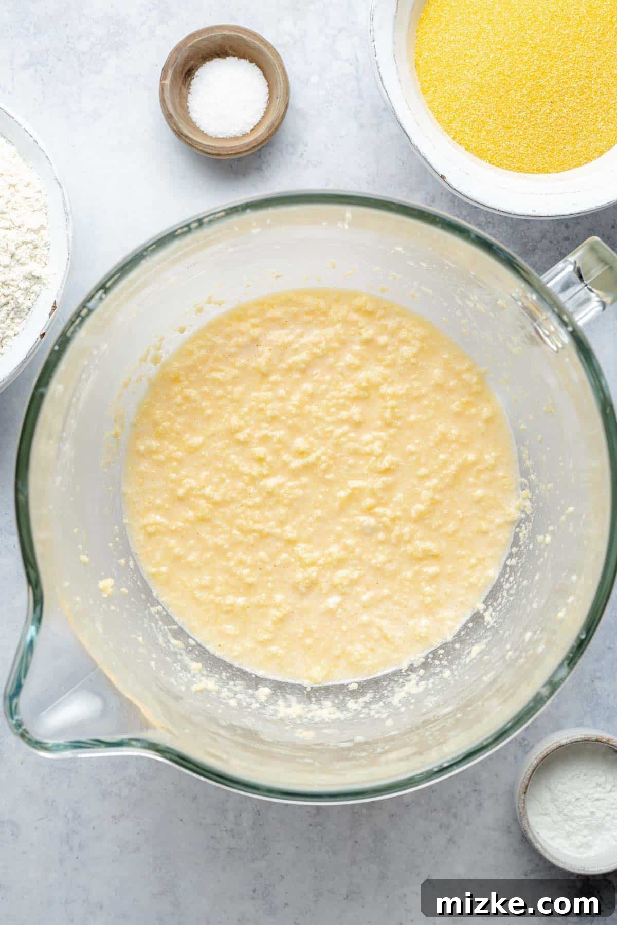 A close-up view of the smooth, creamy wet ingredients (butter, sugar, eggs, milk) mixed in a bowl, ready for the dry ingredients.
