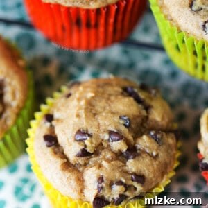 A perfectly baked Banana Peanut Butter Chocolate Chip Muffin, showcasing a delightful golden-brown top and inviting texture.