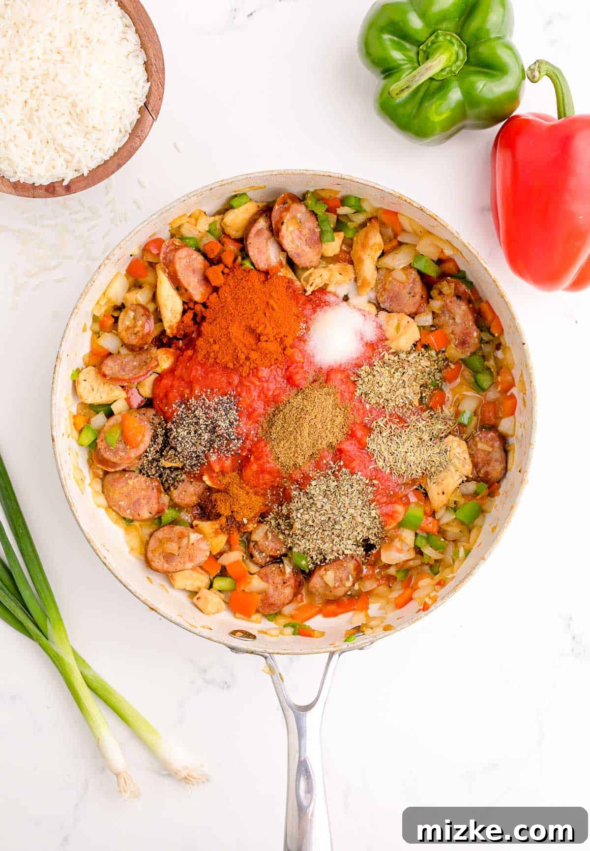 Hearty Chicken and Sausage Jambalaya 6 seasonings added to the skillet with chicken, vegetables, and sausage