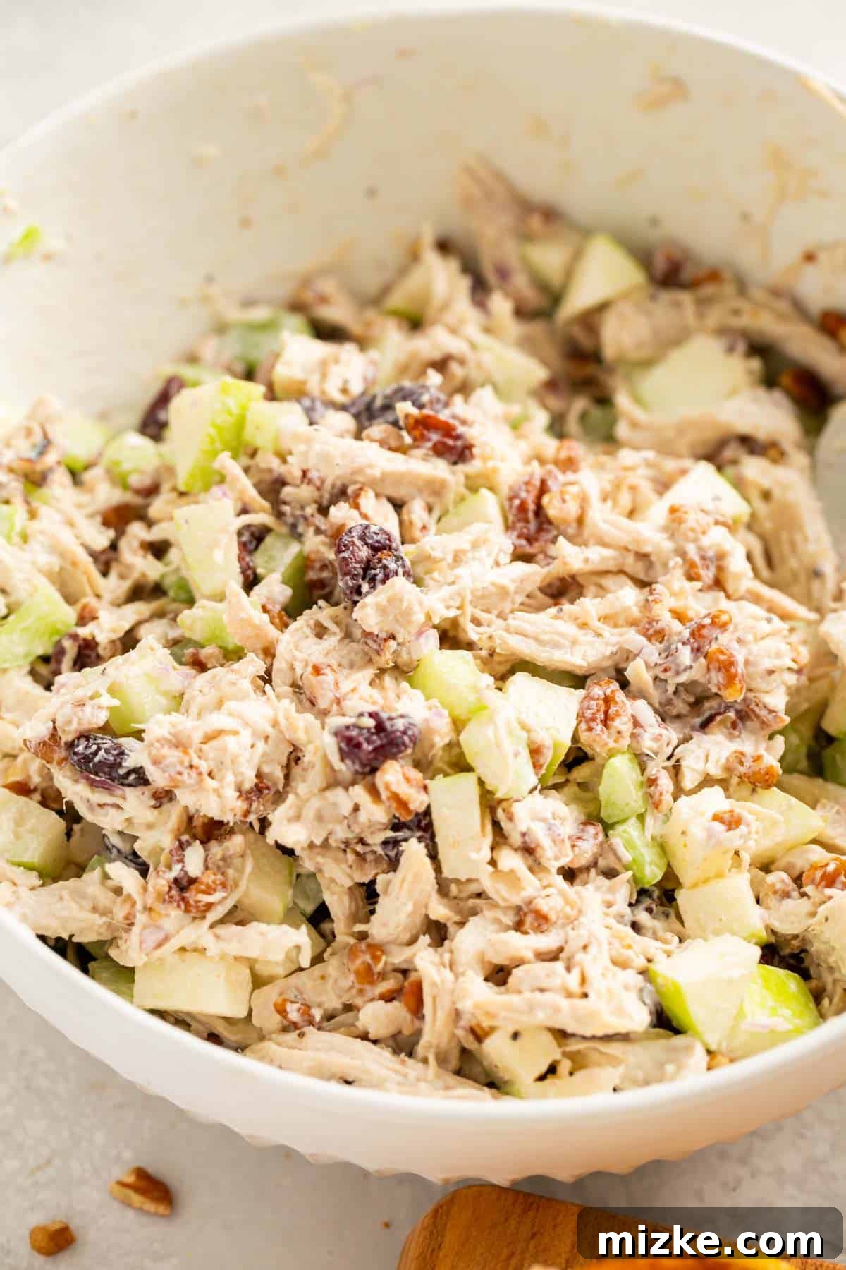 Vibrant Cranberry Pecan Chicken Salad 2 A large white bowl filled with vibrant cranberry pecan chicken salad, showcasing its rich colors and textures.